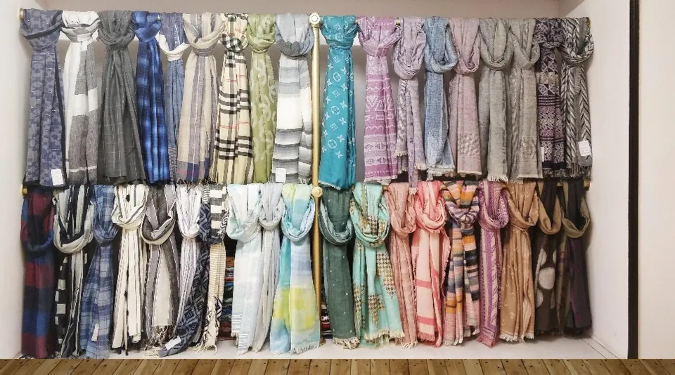 Rack of woven and printed scarf samples